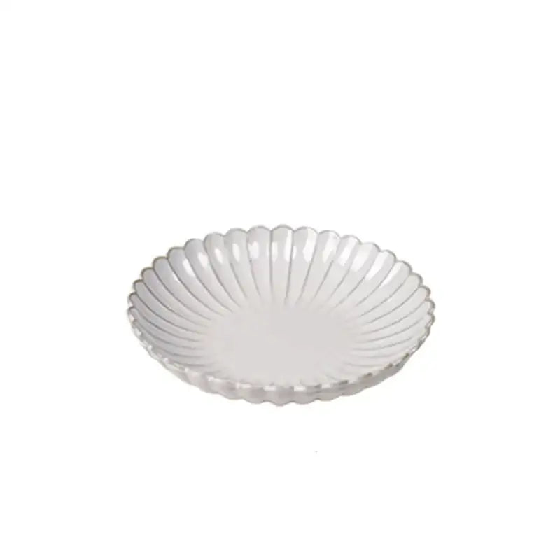 Vintage cream ceramic dining table set featuring a scalloped edge and subtle radial ridges for elegant dining