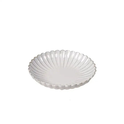 Vintage cream ceramic dining table set featuring a scalloped edge and subtle radial ridges for elegant dining