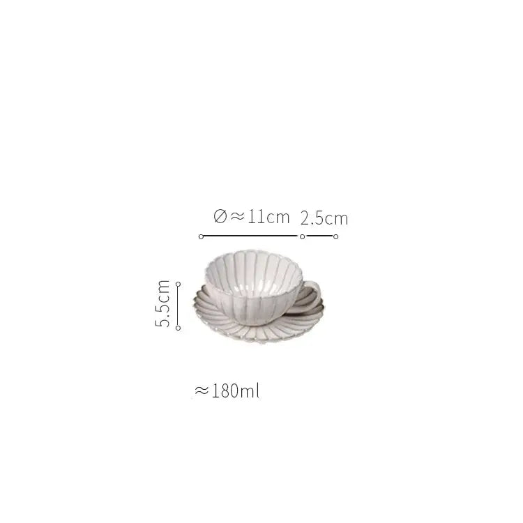 White ceramic teacup and saucer with fluted scalloped design from vintage cream ceramic dining table set