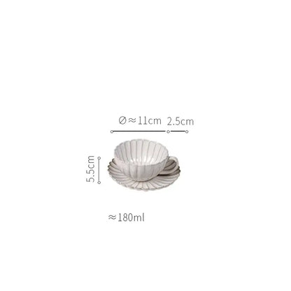White ceramic teacup and saucer with fluted scalloped design from vintage cream ceramic dining table set