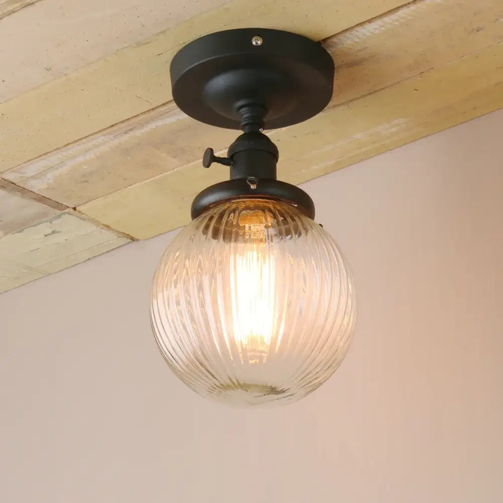 Vintage dark bronze semi flush mount ceiling light with black metal fixture and clear ribbed glass globe for bedroom