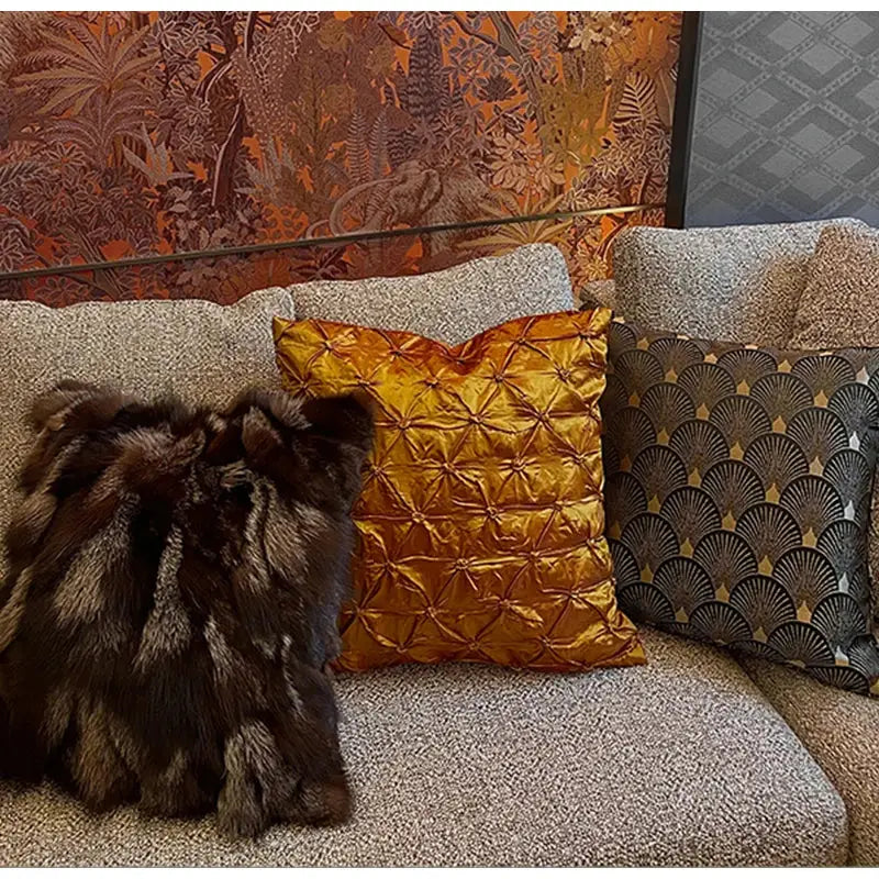 Golden satin cushion cover with quilted starburst pattern paired with vintage dark brown and black decorbites fox fur cushion