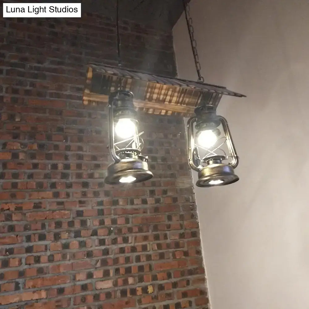 Two vintage dark brown metal island light pendant lights with brass frames emit warm led incandescent light