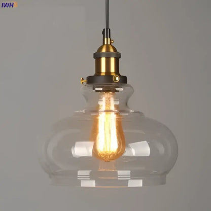 Clear glass pendant lights with brass-finished metal fixtures and exposed edison bulbs set of 4 for dining rooms