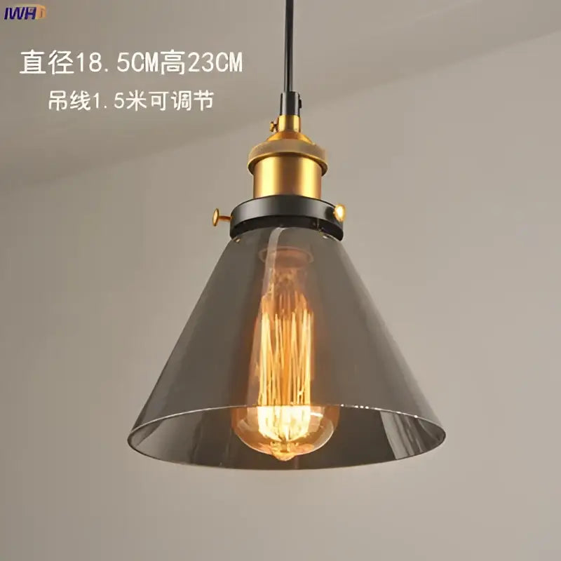 Industrial-style glass pendant light with dark gray shade and brass-finished hardware for dining room lighting
