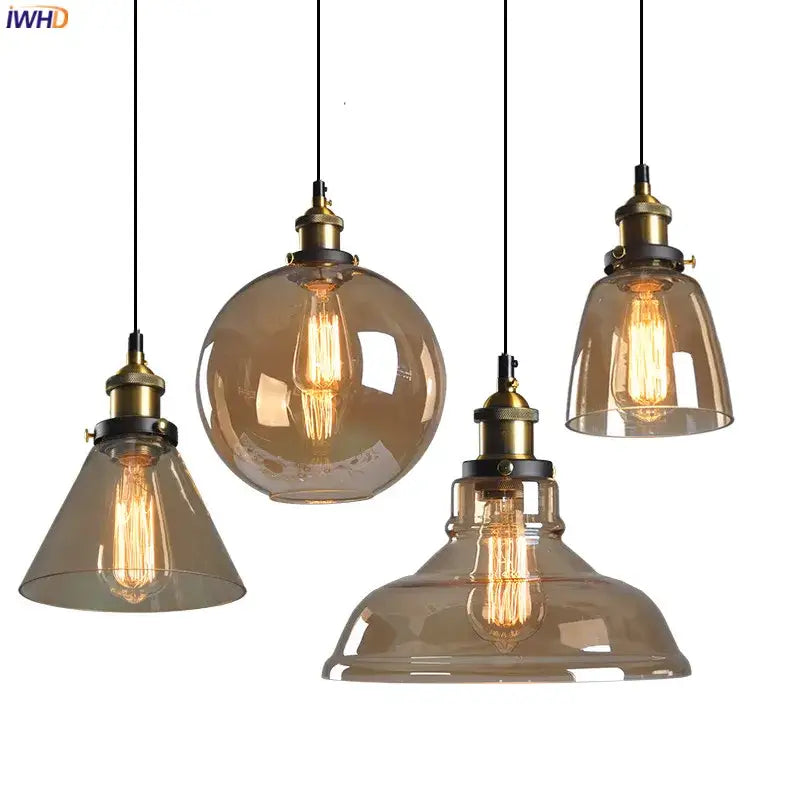 Set of four vintage dark glass pendant lights with amber-tinted glass and brass accents for dining room use