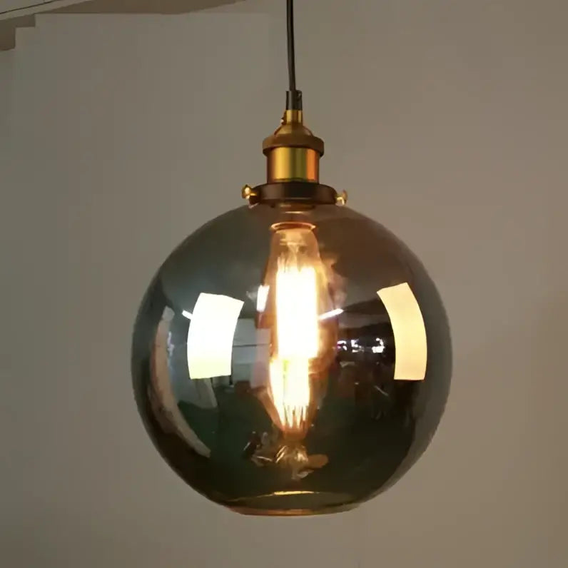 Warm-toned vintage glass pendant lights set of 4 with brass accents and exposed filament bulbs for dining room use