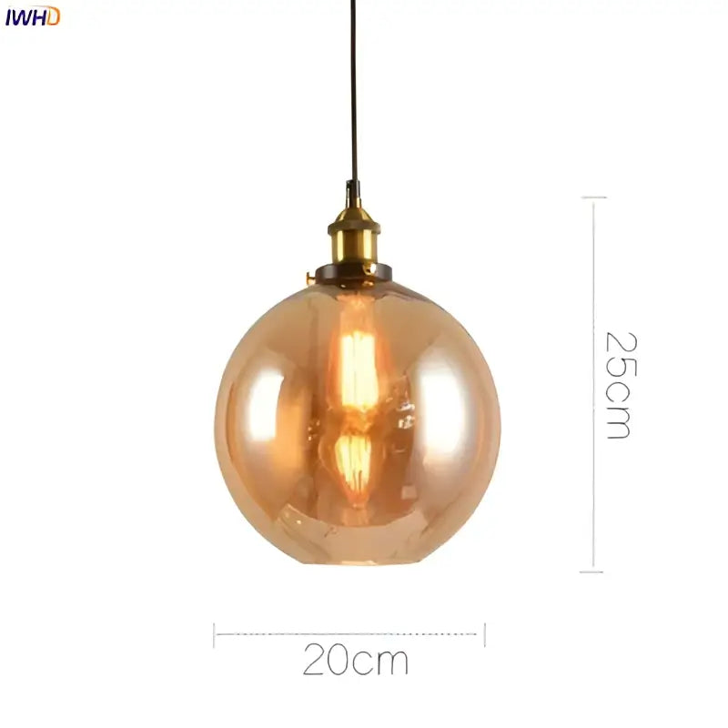 A warm-toned spherical glass pendant light with brass-finished metal fixture for vintage dining room accents