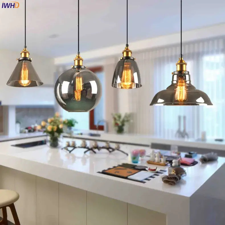 Four vintage glass pendant lights with smoked glass shades and brass accents for dining room lighting