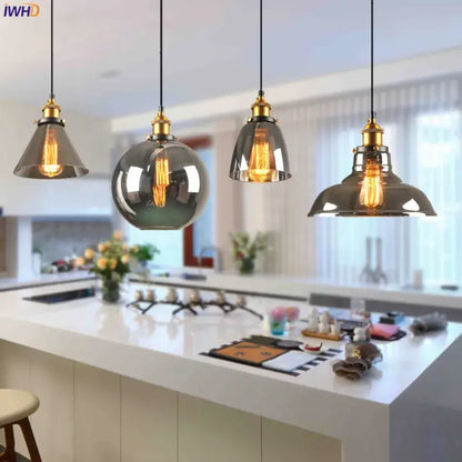 Four vintage glass pendant lights with smoked glass shades and brass accents for dining room lighting