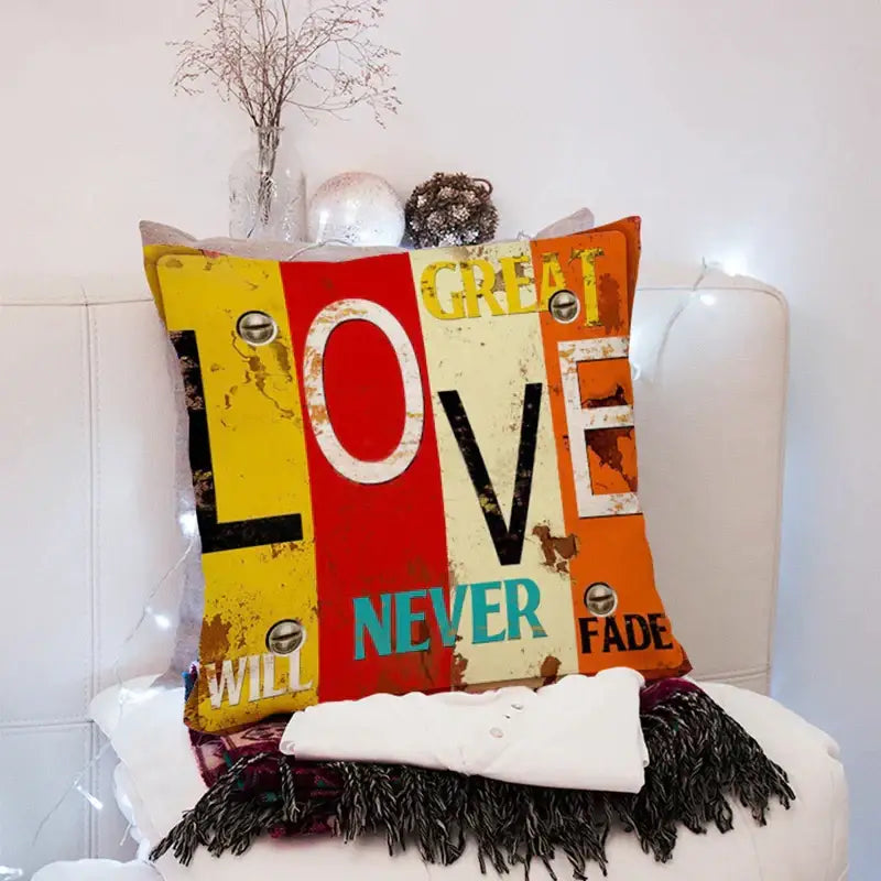 Vibrant distressed vintage-style 45x45cm peach skin throw pillow with love never fade text in yellow red and orange decorbites 45x45cm peach