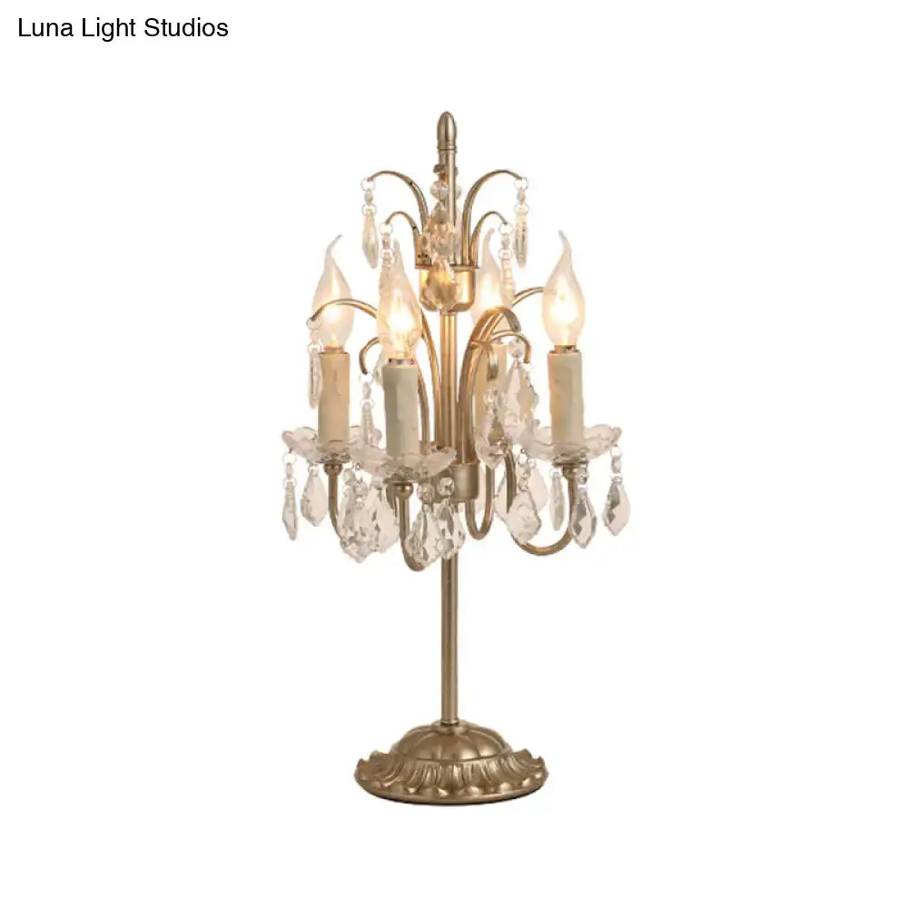 DecorBites vintage metallic nightstand lamp with antique brass finish, five candle bulbs, and hanging crystal droplets