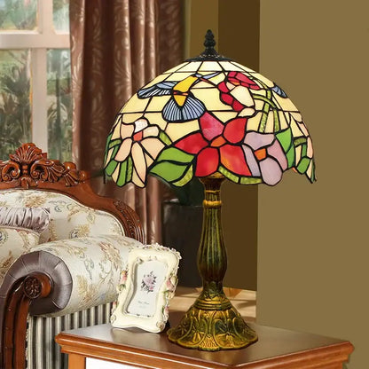 Vintage dragonfly tiffany stained glass table lamp with multicolored floral and hummingbird panels on bronze base