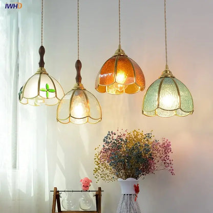 Four hanging pendant lamps with amber green and clear floral glass shades wooden finials and brass accents for decorbites copper wire glass lighting