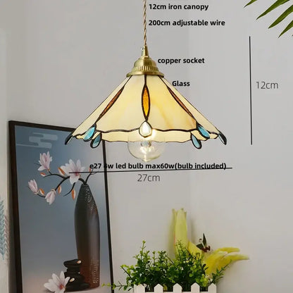 Tiffany-style pendant lamp with brass canopy, cream amber teal stained glass shade, suspended by decorbites copper wire glass
