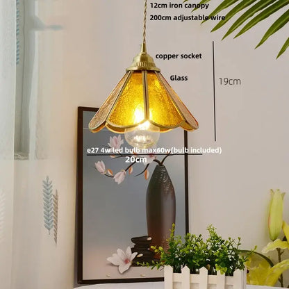Vintage floral glass pendant lamp with warm amber glass, brass canopy, and decorbites copper wire glass suspension