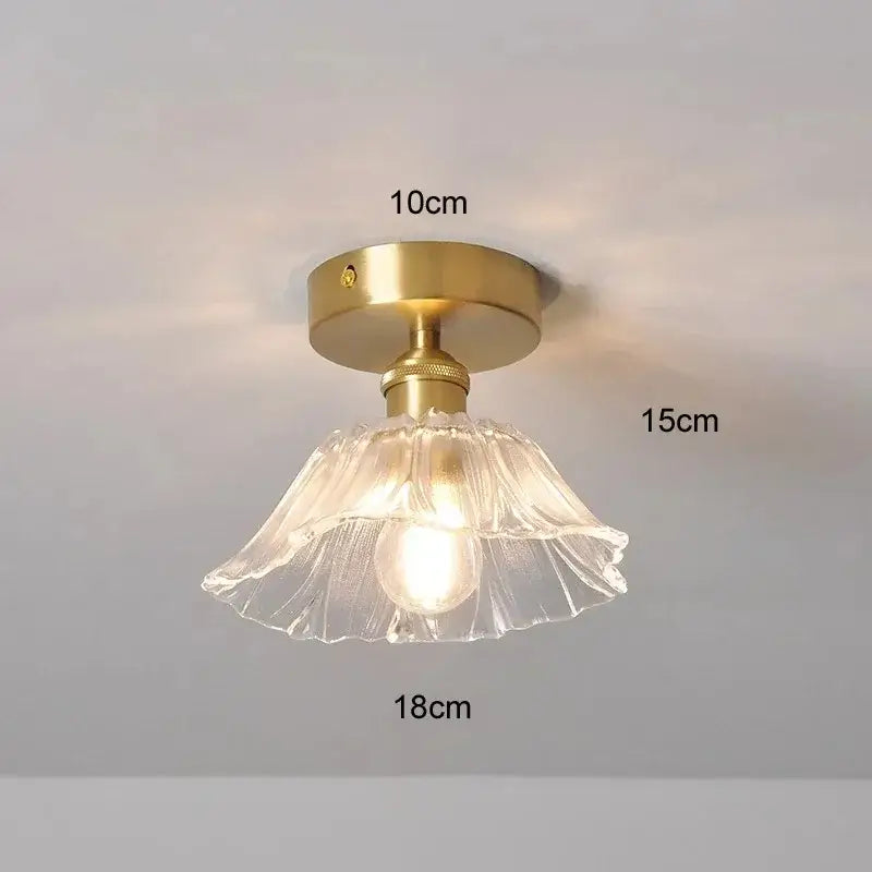 A vintage multi color glass pendant light with a fluted clear glass shade and brass ceiling mount for dining room use