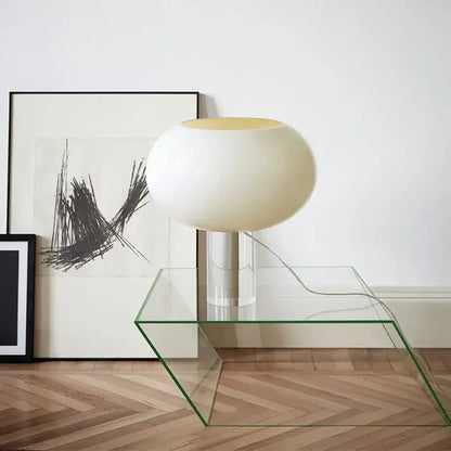 Cream-colored glossy globe table lamp with metallic stem on glass table for warm bedroom decorbites buds table lamp