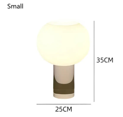 A sleek vintage glass buds table lamp with a frosted white spherical shade and metallic cylindrical base for decorbites buds table