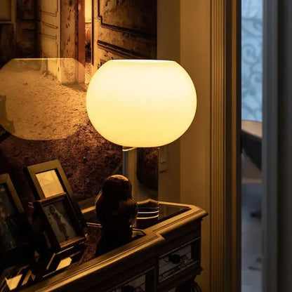 Vintage glasbudd table lamp with warm glowing white glass sphere shade and sleek metallic base for bedroom decor