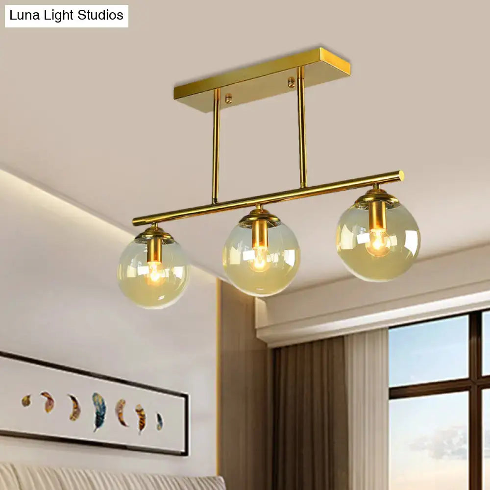 Gold-toned decorbites™ vintage 3-bulb pendant lamp with clear amber glass sphere globes for island lighting