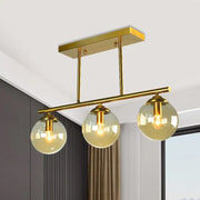 Gold-toned DecorBites vintage 3-bulb pendant lamp with clear amber glass sphere shades and rectangular ceiling mount