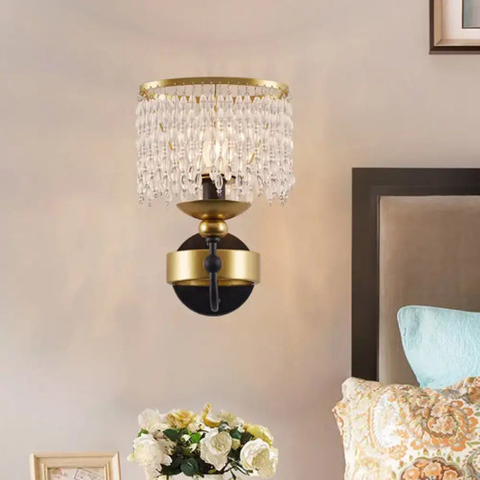Vintage gold and black crystal sconce wall light with a metal frame and retro fringe drape for bedroom use