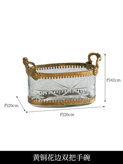 An elegant vintage gold snack plate storage box with carved glass and ornate gold brass handles and borders