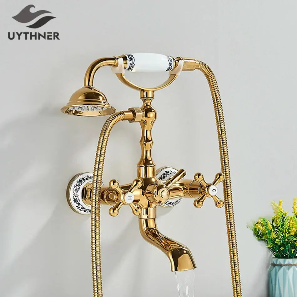 Vintage gold and black bathtub faucet with ornate cross handles and blue floral ceramic knobs by decorbites golden black