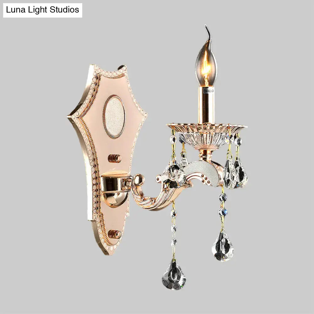 Elegant rose gold direct wired electric sconce light fixture with crystal teardrop pendants and candle-style bulb for bedroom wall mount