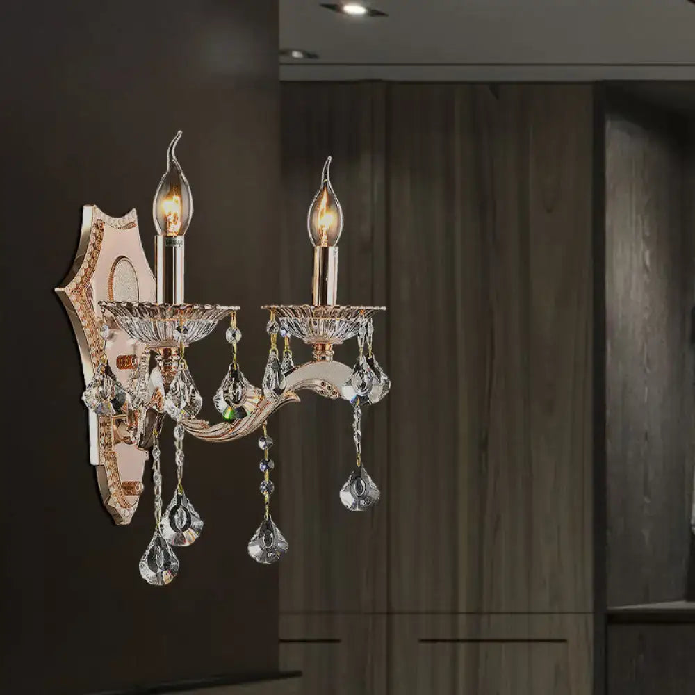 Elegant vintage gold crystal sconce light fixture with two-light direct wired electric design and dangling teardrop crystals