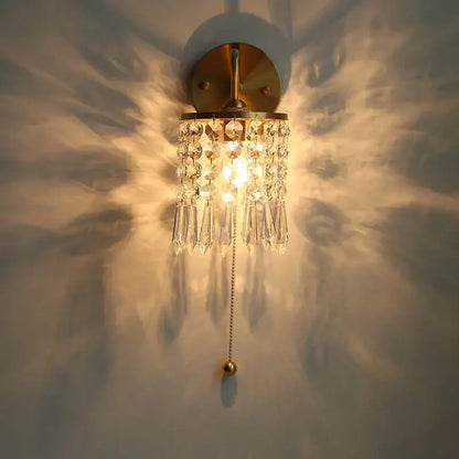 A warm-toned vintage gold crystal wall light stair sconce with cascading clear droplets and pull chain switch decorbites crystal vintage