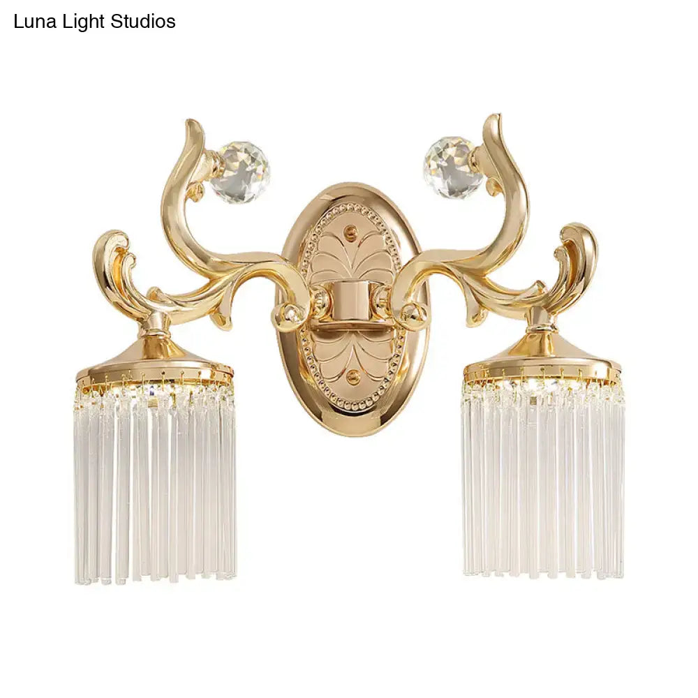 Vintage gold crystal wall mounted light with clear pipe accents featuring ornate gold finish and cascading prisms wall light