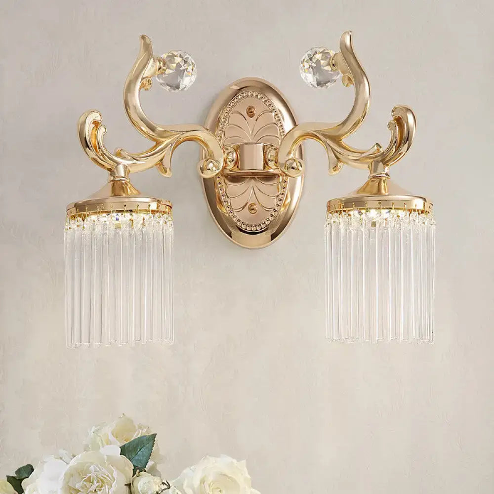 Vintage gold wall mounted light with ornate design clear pipe crystal accents and dangling glass prisms for bedroom