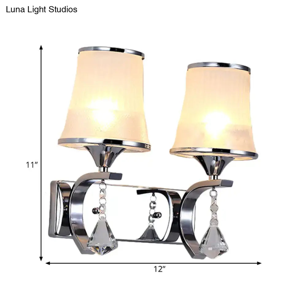 Chrome-finished wall lamp with two frosted beige clear glass shades and dangling crystal teardrop pendants