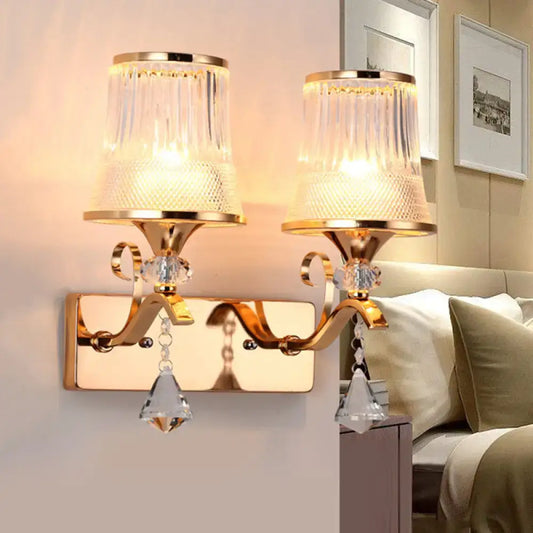 Vintage gold finish wall lamp with clear glass ribbed shades and crystal pendants for elegant bedroom lighting