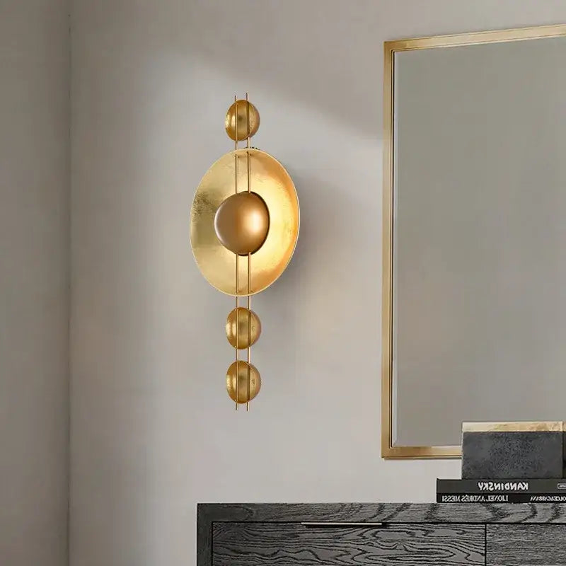 Vintage gold led geometric wall lamp with concentric circular and spherical elements for luxe bedroom decorbites gold led decor