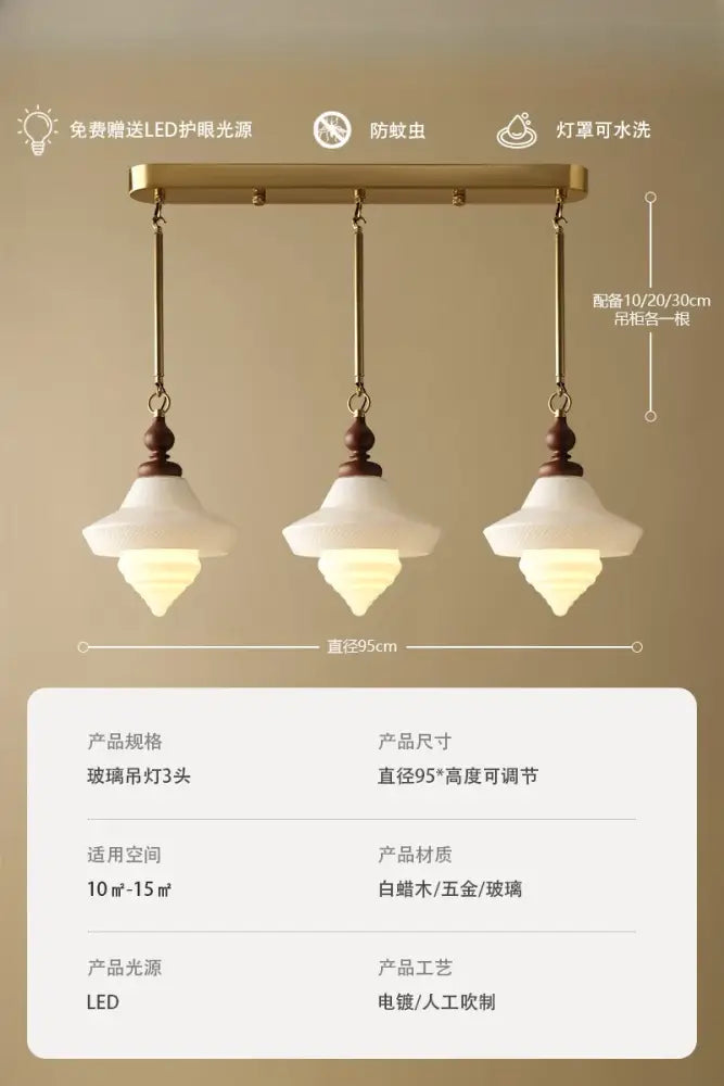 A brass-finished vintage gold lustre glass pendant light with frosted shades and dark wood accents for kitchen islands