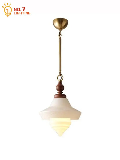 Vintage gold lustre glass pendant lights featuring a brass frame dark wood accent and layered off-white shades for kitchen island decorbites gold lustre