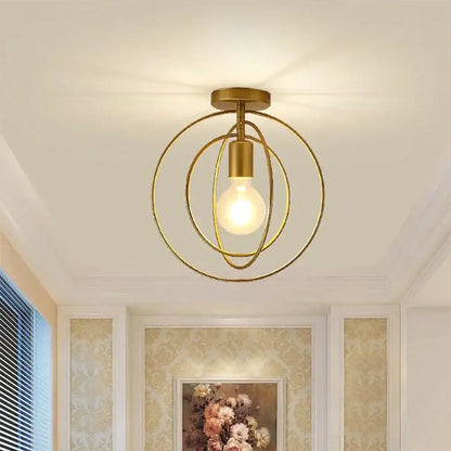 Vintage gold metal cage pendant light with gold-toned spherical design and intersecting rings for restaurant decorbites gold metal