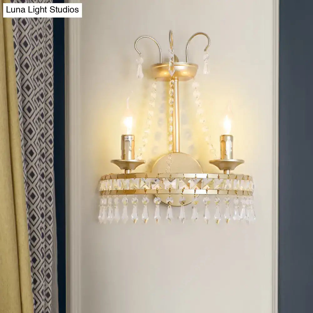 Vintage gold metallic exposed wall lamp featuring two candle-style lights with clear crystal droplets for hallway use