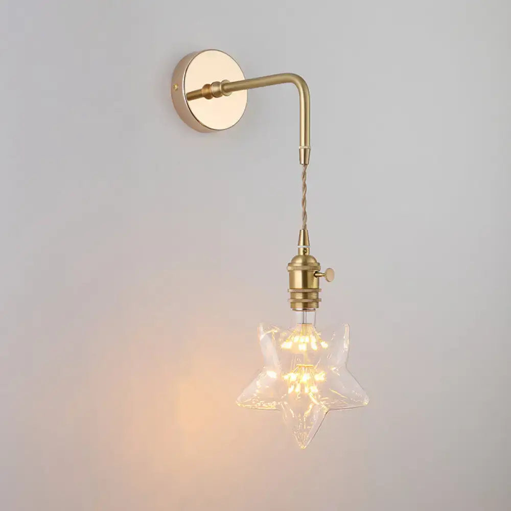 Decorbites vintage single-bulb bedside wall light in brass finish with clear glass star-shaped bulb and shaded glass wall fixture