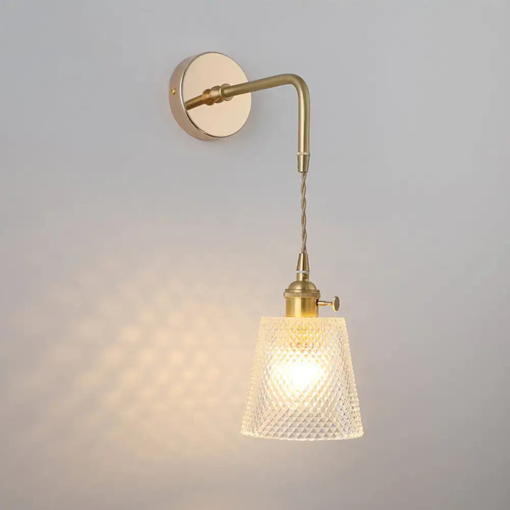 Decorbites vintage single-bulb bedside wall light in warm brass with a textured shaded glass wall light fixture