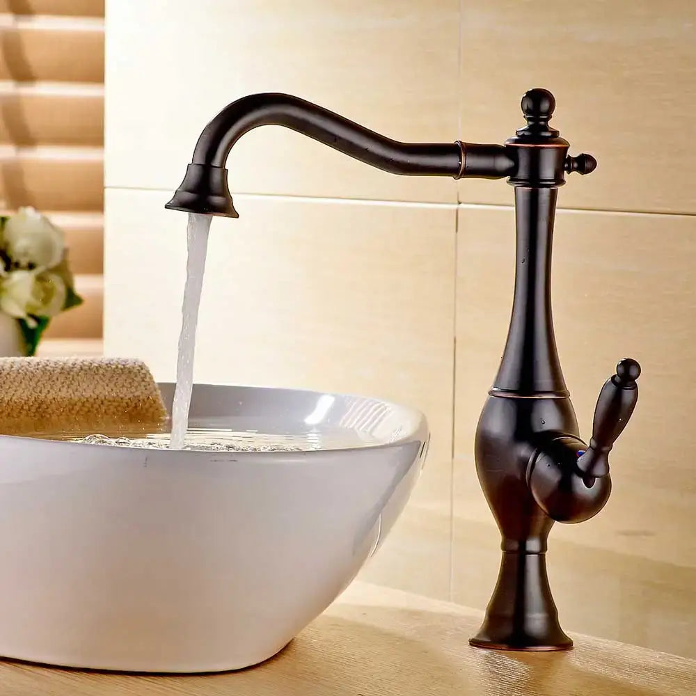 Antique bronze-finished vintage gold single handle basin faucet with curved spout and ornate detailing decorbites golden basin
