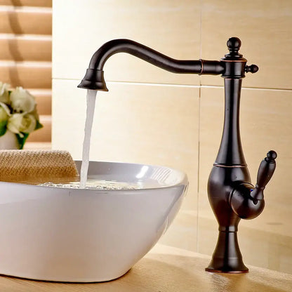 Vintage gold single handle basin faucet in antique bronze finish with curved spout and ornate decorbites golden basin design