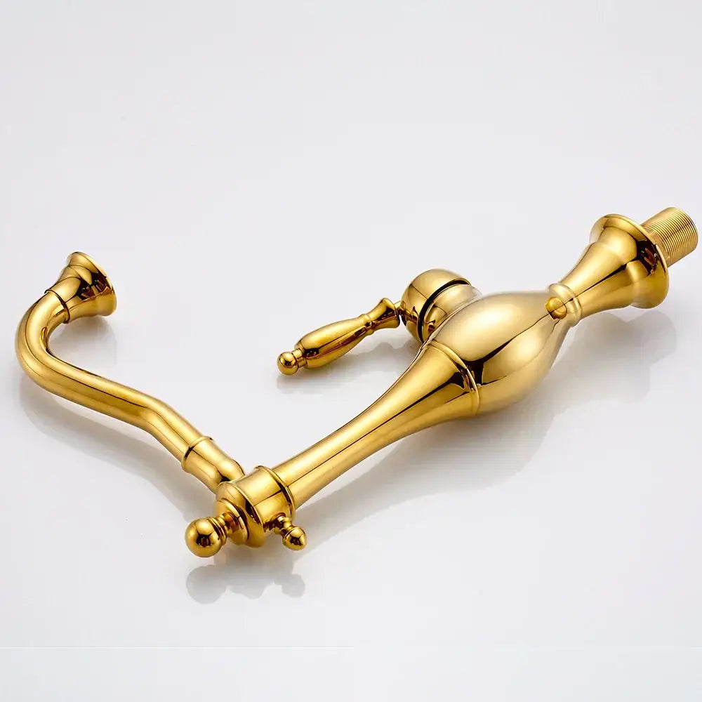Vintage gold single handle basin faucet with ornate design and polished metallic surface for decorbites golden basin use