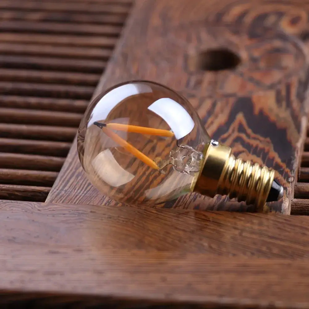Clear glass vintage gold tint g40 led bulb with two orange filaments and brass e14 base for warm decorbites lighting