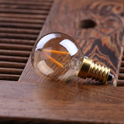 Clear glass vintage gold tint g40 led bulb with two orange filaments and brass e14 base for warm decorbites lighting