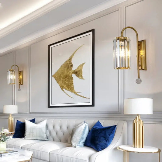 Vintage gold wall light with clear crystal shade featuring gold-leafed angelfish artwork in sleek black frame