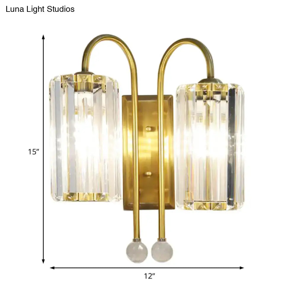 Vintage gold wall light with brass finish featuring two vertical clear crystal shades and spherical glass accents for bedroom sconce